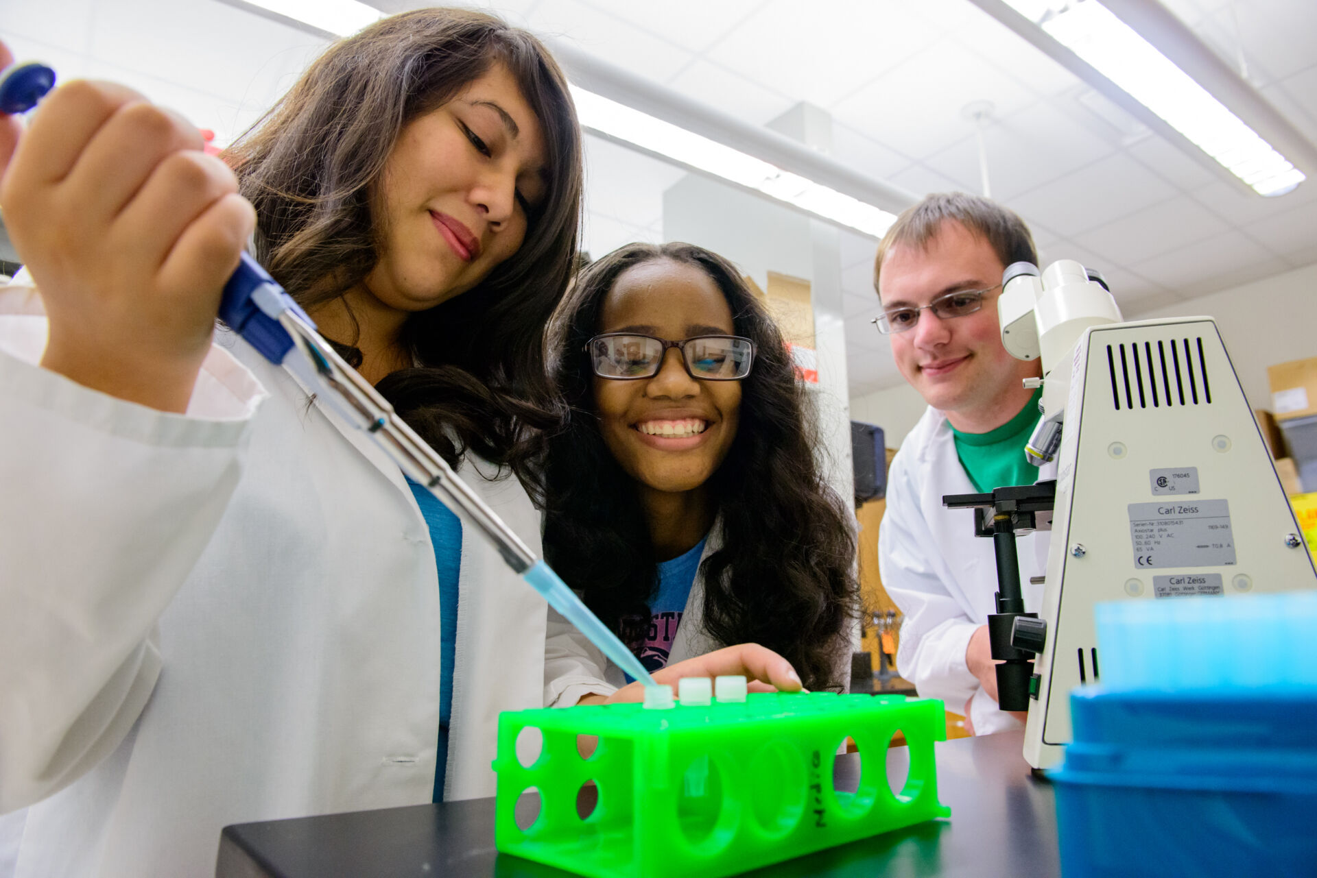 Students gathered around with pipette