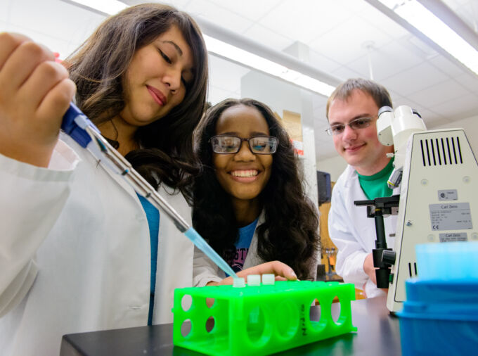 Students gathered around with pipette