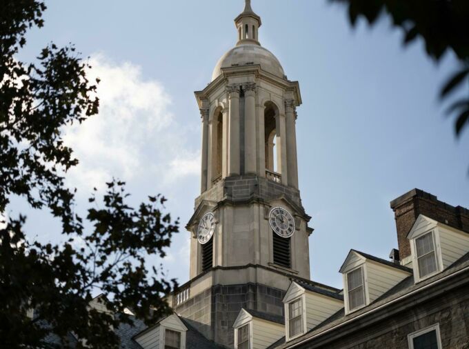 Old Main cuppola viewed from ground, through tree leaves